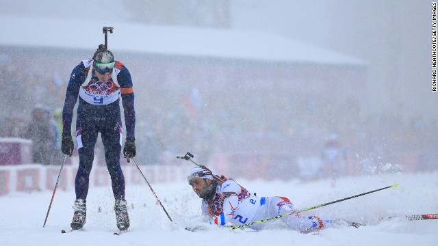 Emil Hegle Svendsen of Norway, left, crosses the line to win gold ahead of Martin Fourcade of France in the men's 15-kilometer mass start biathlon on February 18.