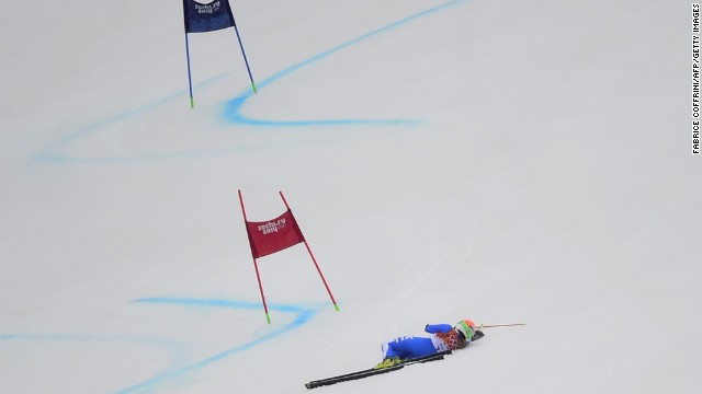 Italy's Denise Karbon lies on the slope after falling during the women's giant slalom on February 18.