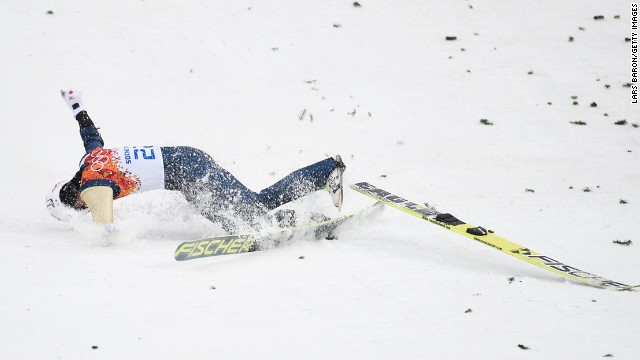 Taihei Kato of Japan crashes as he competes in the large hill Nordic combined event on February 18.