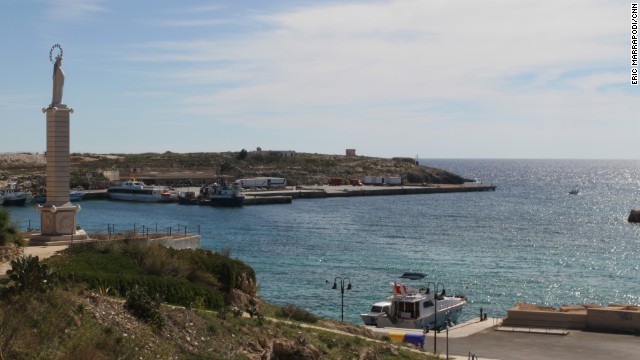 A statue of the Virgin Mary overlooks the harbor.