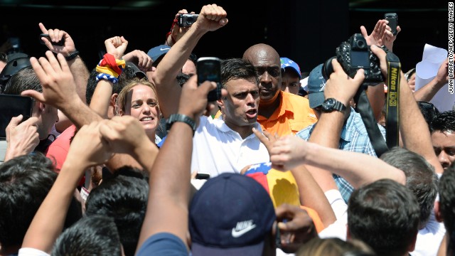 Opposition leader Leopoldo Lopez greets supporters during a demonstration in Caracas on Wednesday, February 12. Lopez was charged with murder, terrorism and arson in connection with the protests, according to his party, Popular Will. Lopez denies the accusations, the party said in a statement.