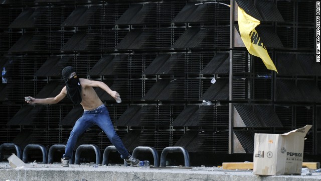 A protester throws a stone in Caracas on February 12.