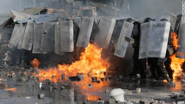 Riot police protect themselves during clashes in Kiev on February 18.