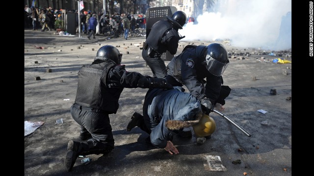 Riot police detain a protester in Kiev on February 18.