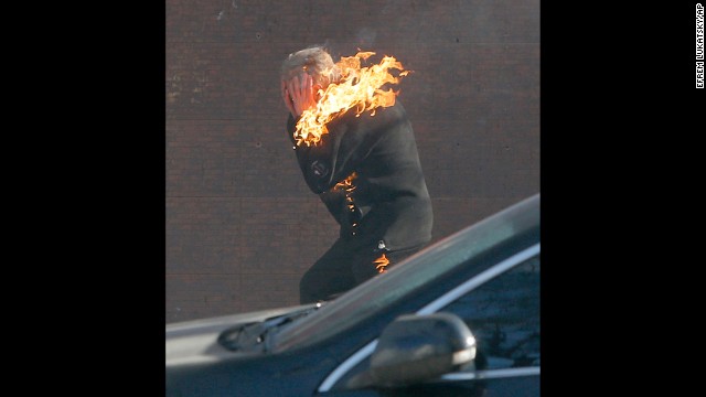 A protester is engulfed in flames while running from the clashes in Kiev on February 18.