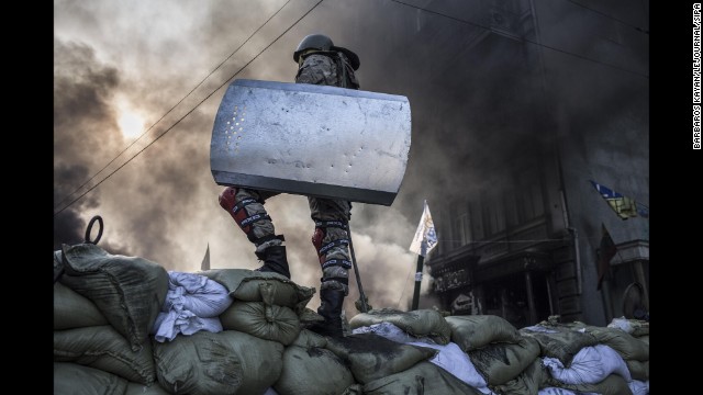 A protester stands atop a barricade in Kiev on February 18.