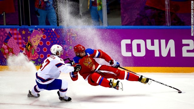 Russian hockey player Alexander Ovechkin, right, falls while playing against Norway's Alexander Bonsaksen during an Olympic game Tuesday, February 18.