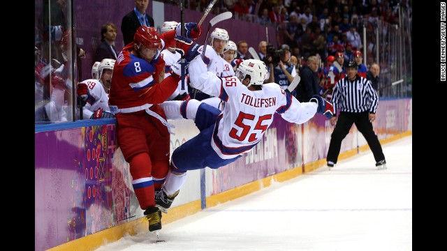 Alexander Ovechkin of Russia checks Ole-Kristian Tollefsen of Norway during the men's hockey game February 18.