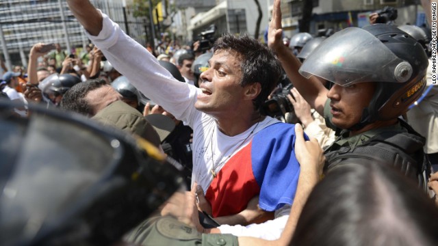 Leopoldo Lopez is escorted by members of the Venezuelan National Guard on Tuesday, February 18, after turning himself in to authorities.