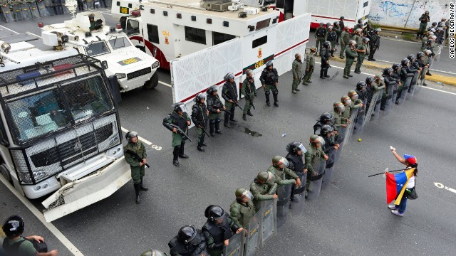 A protester confronts the National Guard as they block the path leading to downtown Caracas on February 18.