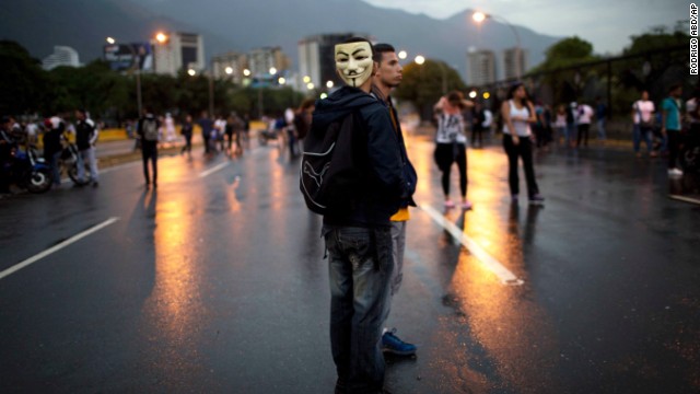 Demonstrators stand on a highway during a protest outside La Carlota airport in Caracas on February 18.