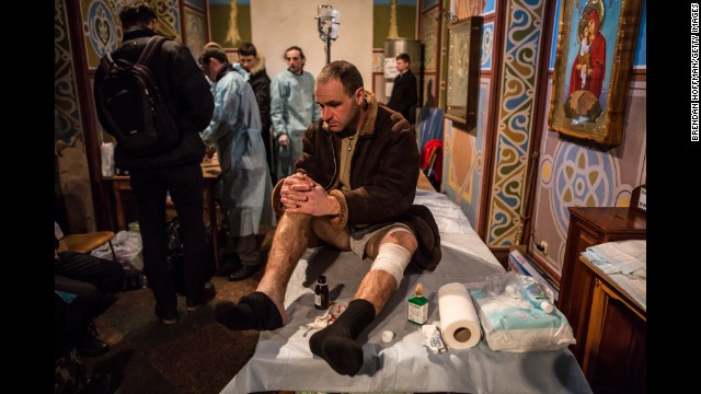 An injured protester waits to be treated in a Kiev monastery, converted into a makeshift hospital, on February 19.