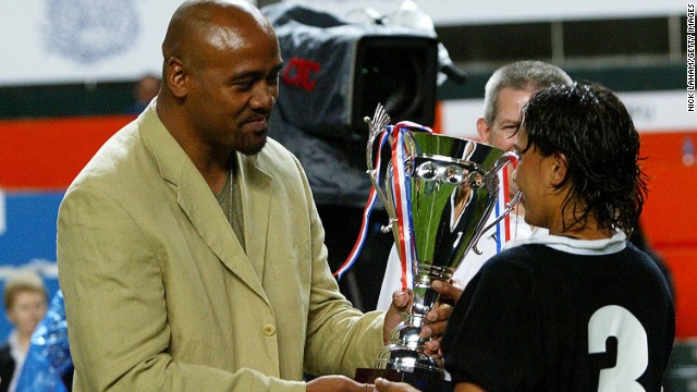 Lomu's last international match was in late 2002, but after his kidney transplant he played club rugby sporadically until 2010. Here Lomu presents Annie Brown of New Zealand with the Women's Rugby Sevens trophy during the 2004 Hong Kong Sevens. 