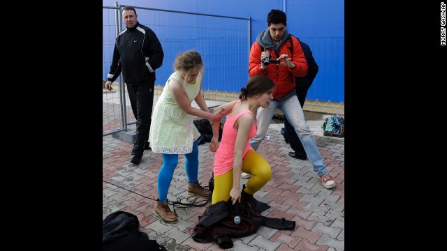 Band member Maria Alyokhina helps up Tolokonnikova on February 19. A day earlier, members of the band as well as journalists and Russian human rights activists were detained for several hours at a police station.