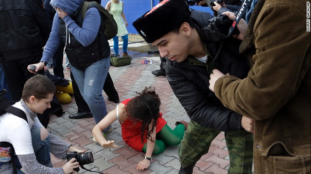 A member of Pussy Riot lies on the ground February 19. The band has been highly critical of Russian President Vladimir Putin and his policies, and Alyokhina and Tolokonnikova were even imprisoned for a 2012 "punk prayer" performance at a Russian Orthodox cathedral. 