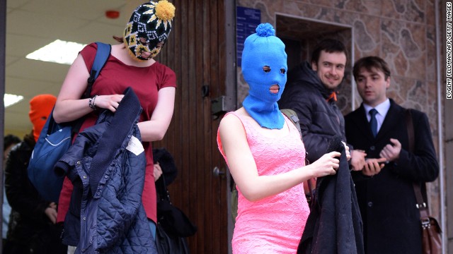 Tolokonnikova, wearing the blue mask, and other band members leave the police station on February 18.