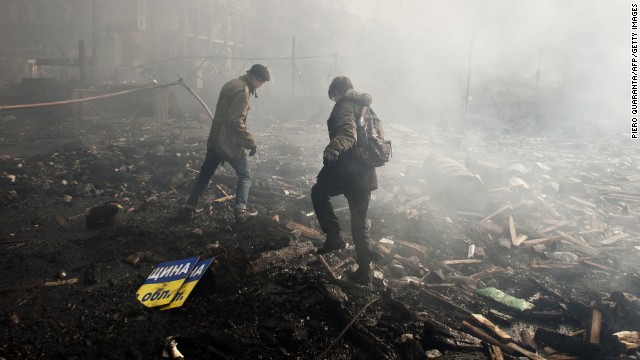 Protesters walk in the rubble of Independence Square on February 19.