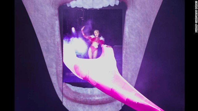 Cyrus opens her Bangerz Tour on February 14, 2014 in Vancouver, Canada. The stage features a giant image of Cyrus' face with her signature exposed tongue serving as a slide.