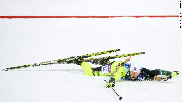 Biathlete Matej Kazar of Slovakia falls over the finish line during the mixed relay event on February 19.