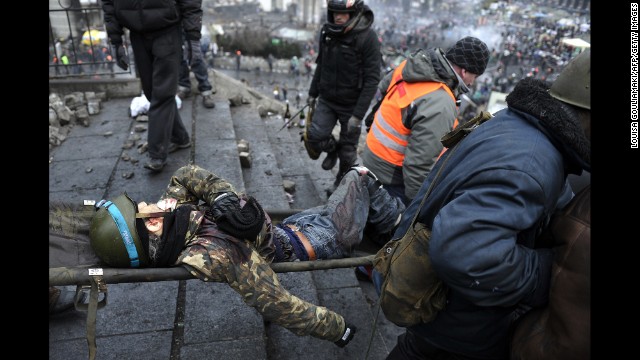 An injured demonstrator is carried away from Independence Square on February 20.