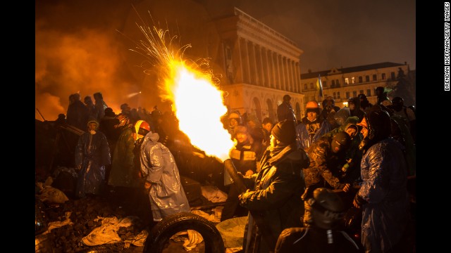 Protesters use a compressed air cannon to launch a Molotov cocktail toward police lines in Independence Square on February 19.