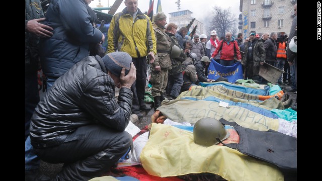 Activists pay their respects to protesters who were killed in clashes with police in Independence Square on February 20.