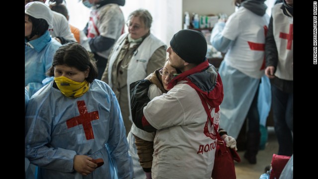 Medics embrace in the lobby of the Hotel Ukraine on February 20.