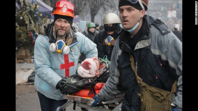 An injured protester is carried away from Independence Square on a stretcher February 20. 