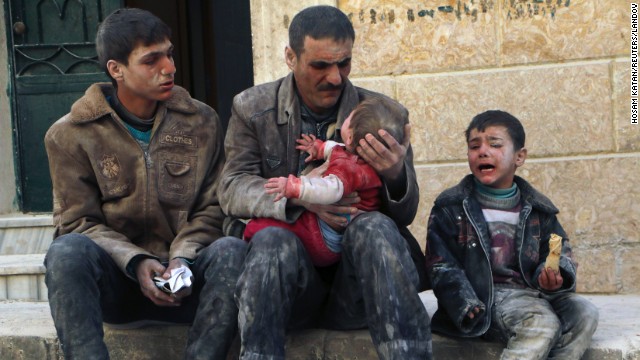 A man holds a baby who survived what activists say was an airstrike by al-Assad loyalists Friday, February 14, in Aleppo.