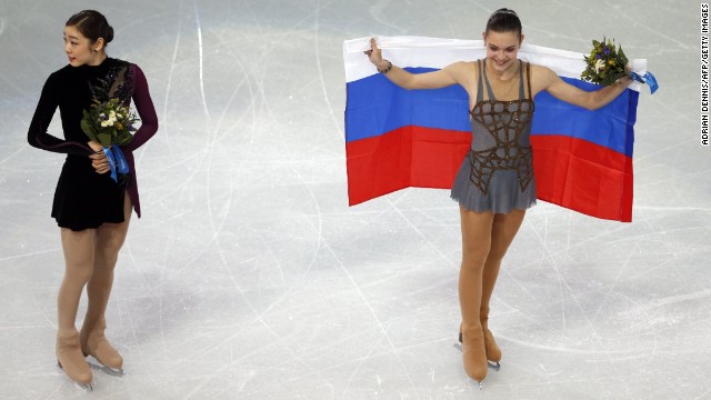 Gold medalist Adelina Sotnikova of Russia, right, and silver medalist Yuna Kim of South Korea take part in the flower ceremony after the women's free skating program in Sochi, Russia, on Thursday, February 20. Some are questioning the scores given to the skaters since Kim seemingly had a better overall performance.