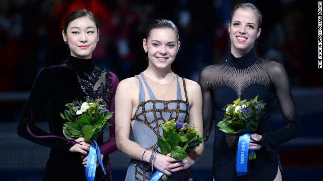 Kim, left, and Sotnikova were accompanied by bronze medalist Carolina Kostner of Italy during the flower ceremony.