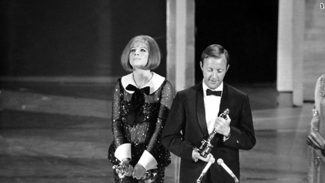 In 1969 the Academy makes history with a tie: Barbra Streisand is named best actress for her role in "Funny Girl" and Katharine Hepburn for her role in "The Lion In Winter." Streisand is seen here beside British director Anthony Harvey, who accepts the award on Hepburn's behalf.