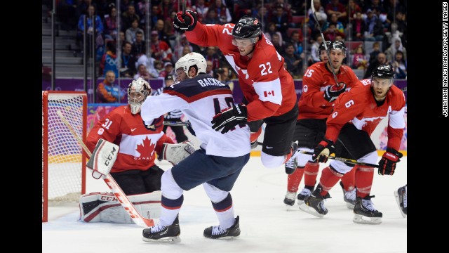 Players look toward the corner of the rink during the hockey semifinal between Canada and the United States.