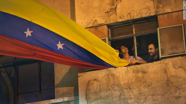 A woman waves a Venezuelan flag out of her Caracas window on February 21.