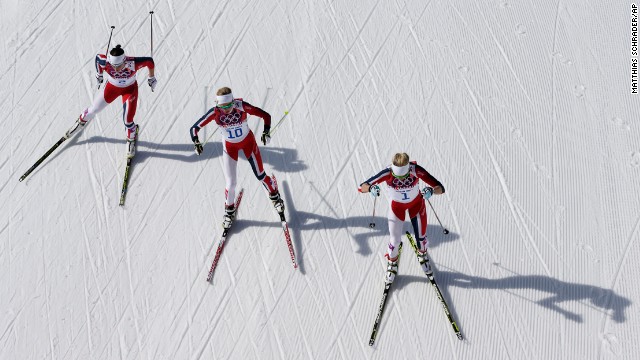 From left, gold medal winner Marit Bjoergen, bronze medal winner Kristin Stoermer Steira and silver medal winner Therese Johaug, all from Norway, ski during the 30-kilometer cross-country race on February 22.