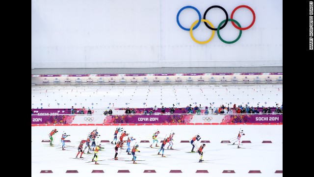 Skiers pass the Olympic rings as they compete during the men's 4x7.5-kilometer cross country relay on February 22. 