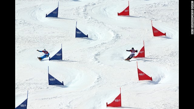 Vic Wild of Russia, right, and Benjamin Karl of Austria compete in the men's parallel slalom snowboard semifinals on February 22. 