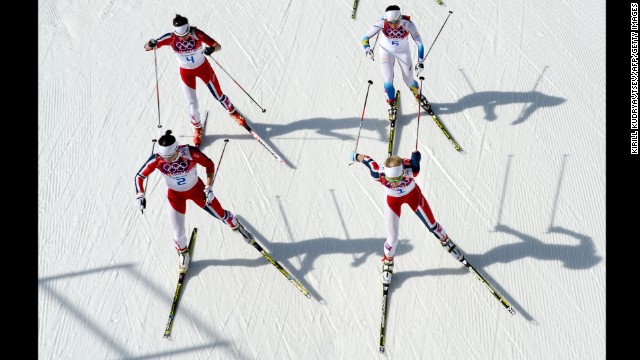 Norway's Marit Bjoergen, front left, and Norway's Therese Johaug are followed by Norway's Heidi Weng and Sweden's Charlotte Kalla on February 22 as they compete in the women's cross-country skiing 30-kilometer mass start free.