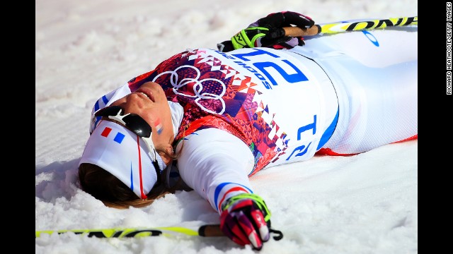 Coraline Hugue of France collapses after the women's 30-kilometer mass start free cross-country event on February 22. 