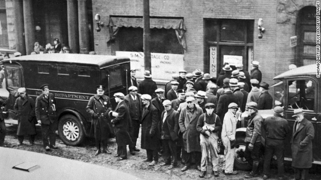 Police and spectators gather in front of the garage on Chicago's North Clark Street, where members of Al Capone's gang, disguised as policemen, shot and killed seven members of a rival gang on February 14, 1929. The St. Valentine's Day Massacre became a symbol of the extreme violence of the Chicago underworld and crime boss Al Capone.