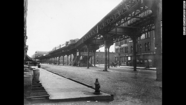 Chicago's famous "L" (short for "elevated" train) started moving residents around town in 1892. That makes it the second-oldest transit system in the country behind the one in Boston. Here, a steam-powered "L" train comes down the railway on Market Street near Lake Street on June 30, 1895. 