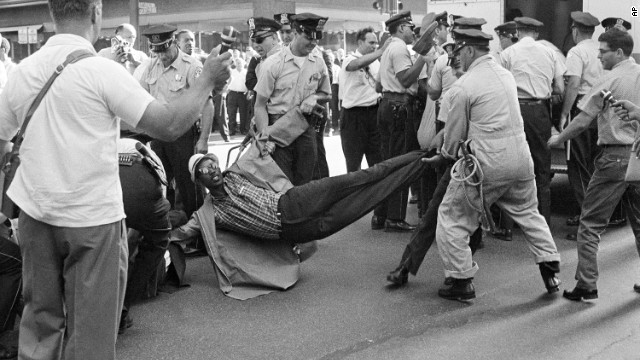 Chicago police drag away one of 80 civil-rights marchers who were arrested after staging a rush hour sit-in on a downtown street in Chicago on June 28, 1965. Leaders of the march, dissatisfied with results of a two-hour meeting with the mayor, ordered marchers to assume "arrest position."