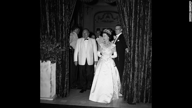 Queen Elizabeth II enters the Grand Ballroom of the Hilton Hotel in Chicago on July 6, 1959. She was attending a banquet held by Chicago Mayor Richard J. Daley, seen at left in the bow tie. Daley and his son, Richard M. Daley, presided over Chicago as mayor for 42 combined years.