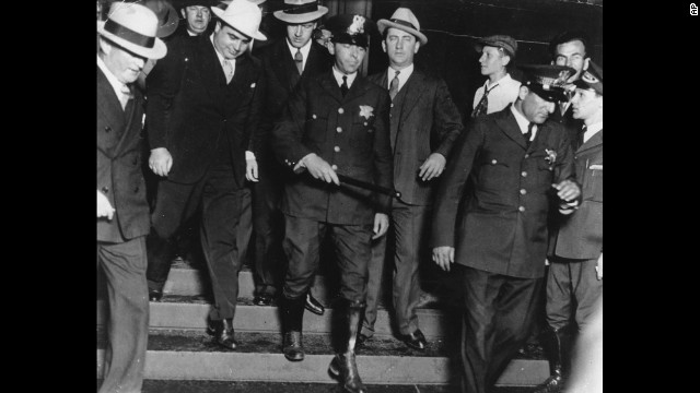 Al Capone -- on the left, wearing the all-white hat -- leaves a Chicago courtroom in the custody of U.S. marshals in October 1931. Capone ran gambling, prostitution and bootlegging operations across Chicago until he was indicted in 1931 for tax evasion. He was convicted and spent the next 11 years in prison.