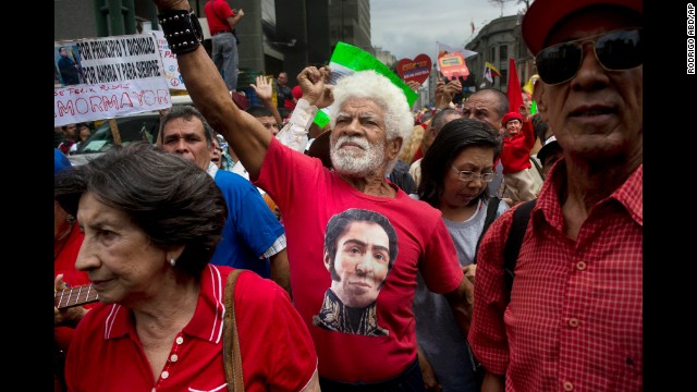 A man wearing a T-shirt with the likeness of Latin American hero Simon Bolivar joins in a pro-government march in Caracas on Sunday, February 23.
