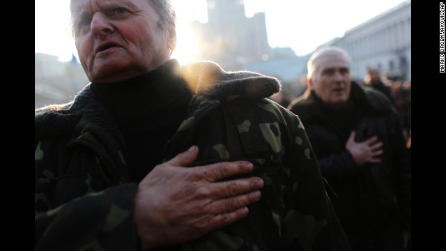 People sing the Ukrainian national anthem at Kiev's Independence Square on Monday, February 24.