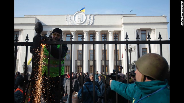 Protesters remove a fence that surrounds Ukraine's parliament in Kiev on February 26.