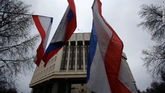 Pro-Russia demonstrators wave Russian and Crimean flags in front of a local government building in Simferopol during a protest February 27. Simferopol is the capital of Crimea, an autonomous republic of Ukraine with an ethnic Russian majority.