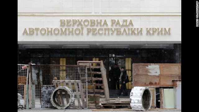 Protesters stand in front of a government building in Simferopol on February 27. Tensions have simmered in the Crimea region since the Ukraine president's ouster.<!-- -->
</br>