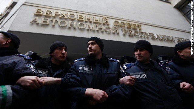 Security forces stand guard during clashes between opposing sides in front of Crimea's parliament building in Simferopol on February 26.